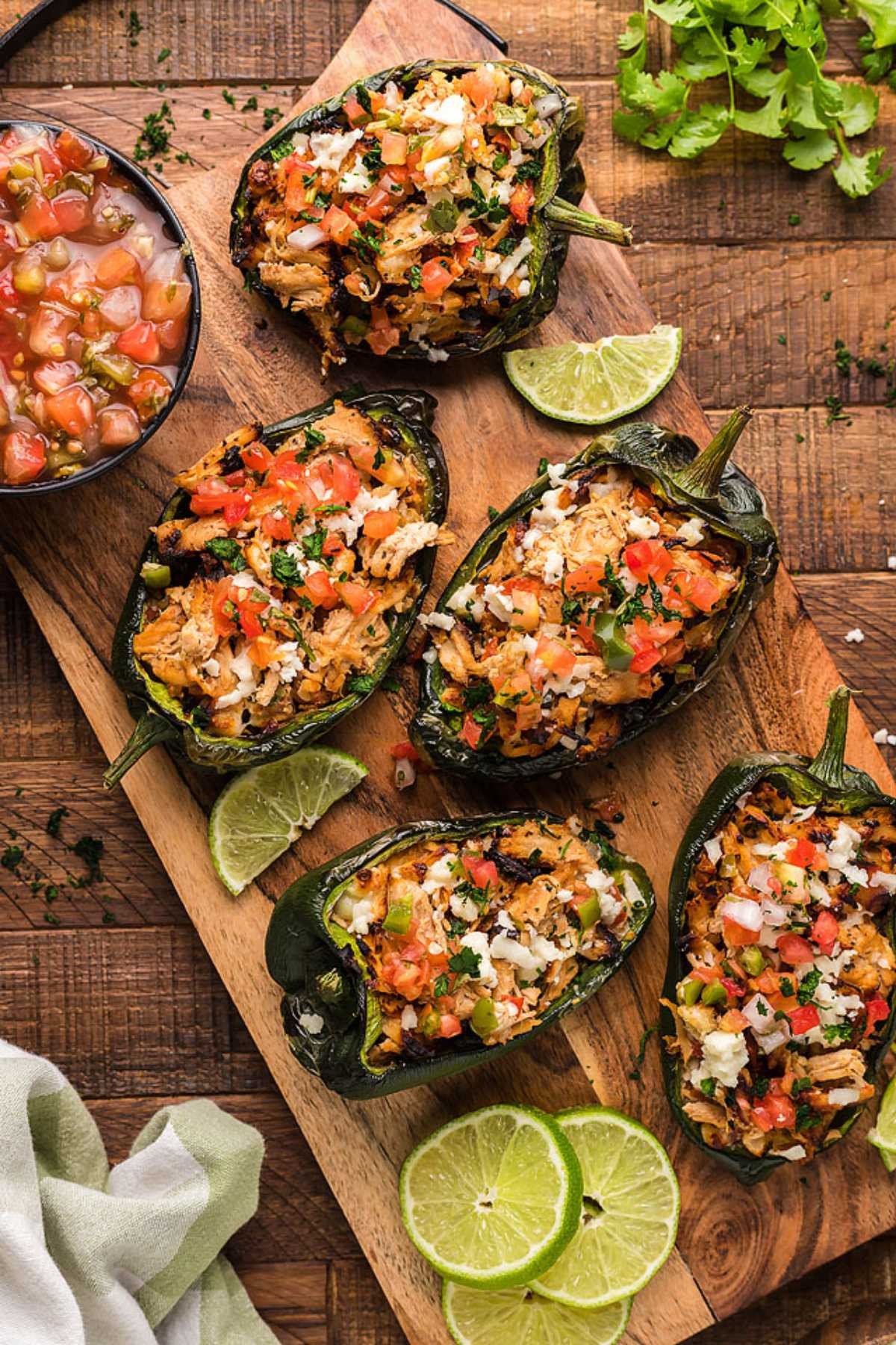margarita chicken stuffed bell peppers garnished with cilantro and lime wedges