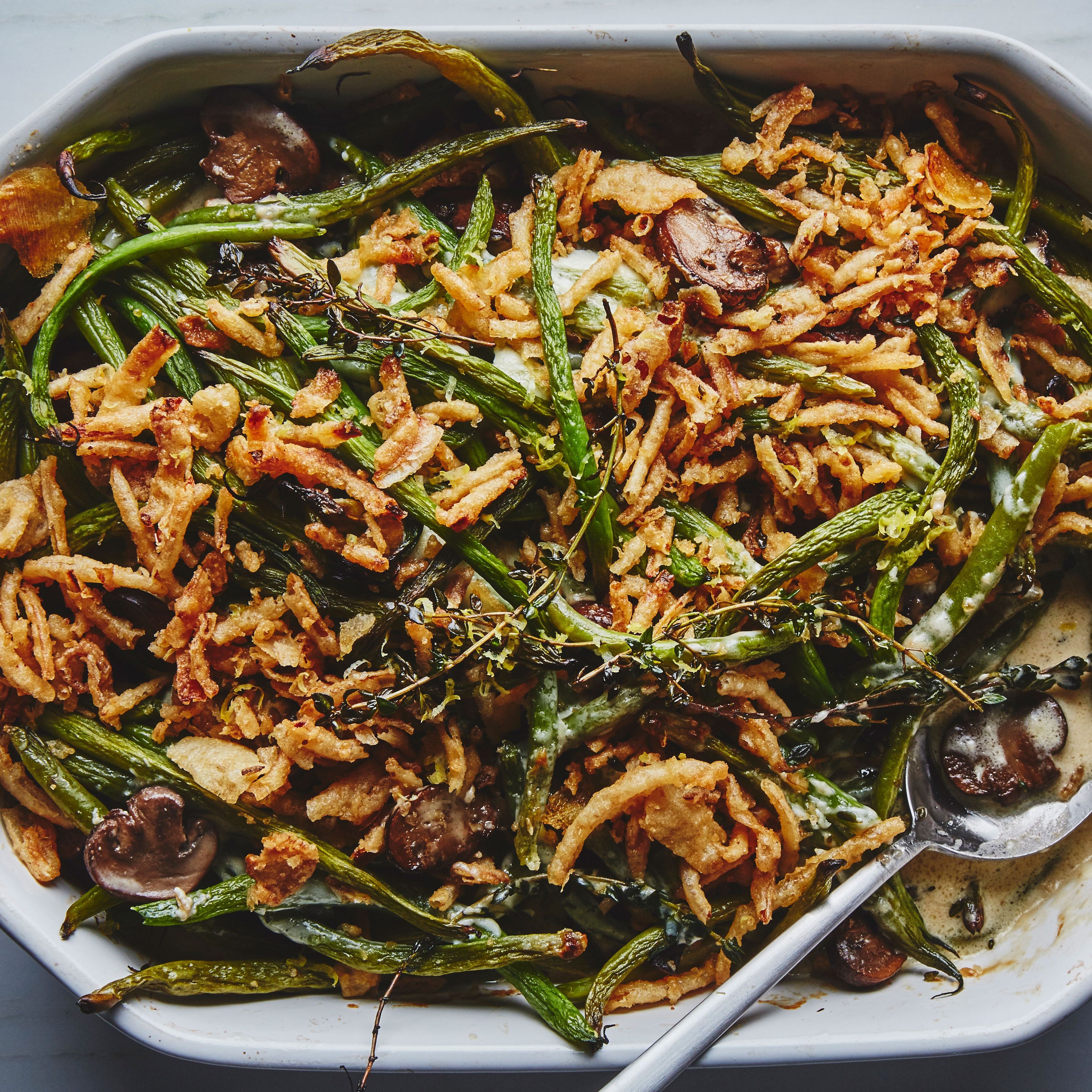 golden brown skillet green bean casserole with crispy onions and fresh herbs